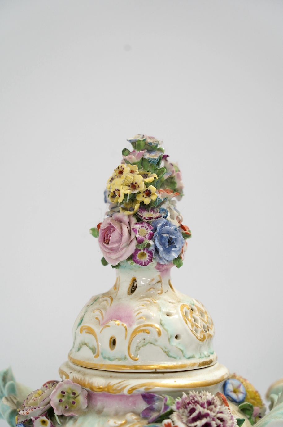 A pair of Potschappel porcelain floral encrusted vases and covers, 31cm high. Condition - poor